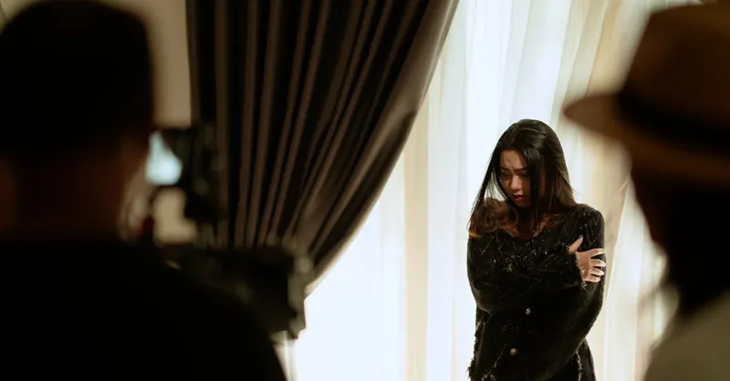 A woman actor performing a scene indoors, captured with dramatic lighting and intense emotion.