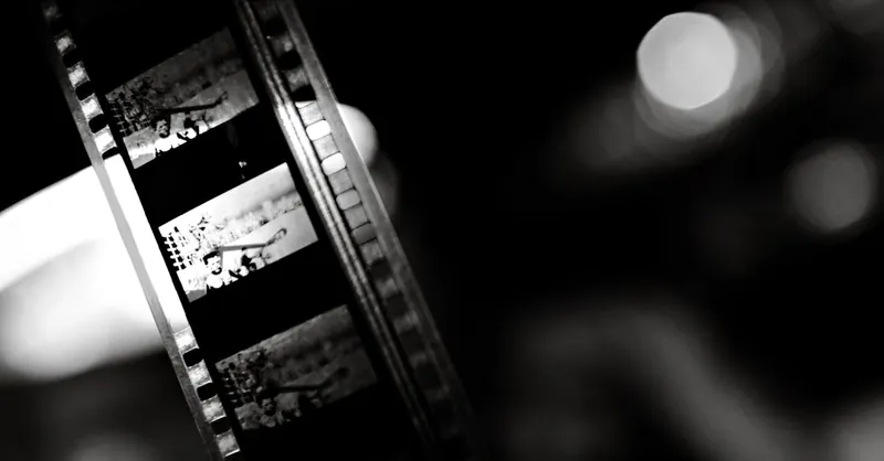 A close-up of a vintage film strip in black and white, capturing the essence of classic cinema.