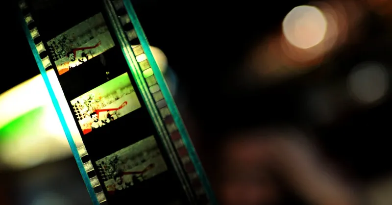 Close-up of a vintage film reel showcasing vibrant colors and cinematic art, highlighting the essence of classic filmmaking.