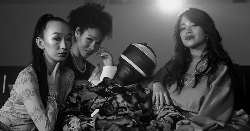 A diverse group of friends experiencing virtual reality in a movie theater setting. Black and white aesthetics.