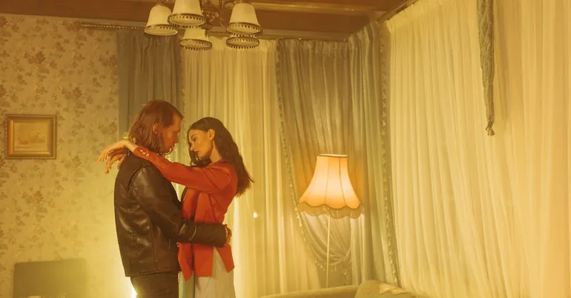 An intimate and romantic scene of a couple dancing closely in a vintage living room.