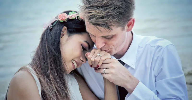 A loving couple shares a tender moment by the seaside, symbolizing romance and connection.