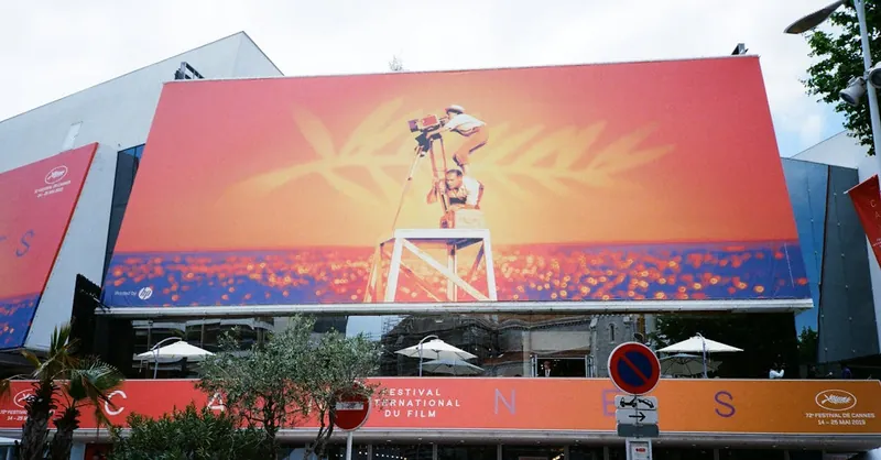 Large billboard at the Cannes Film Festival showcasing vibrant imagery.